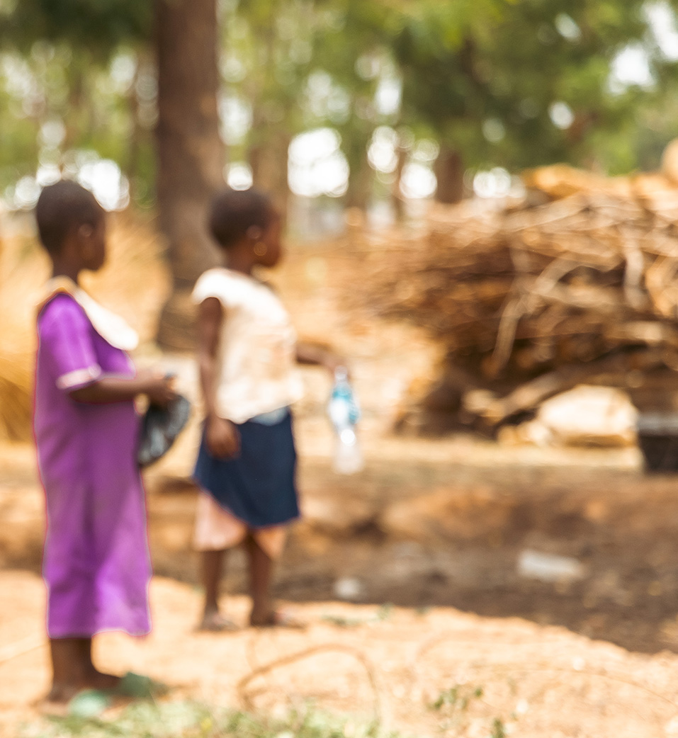 A blurry image of two African children facing away from the camera