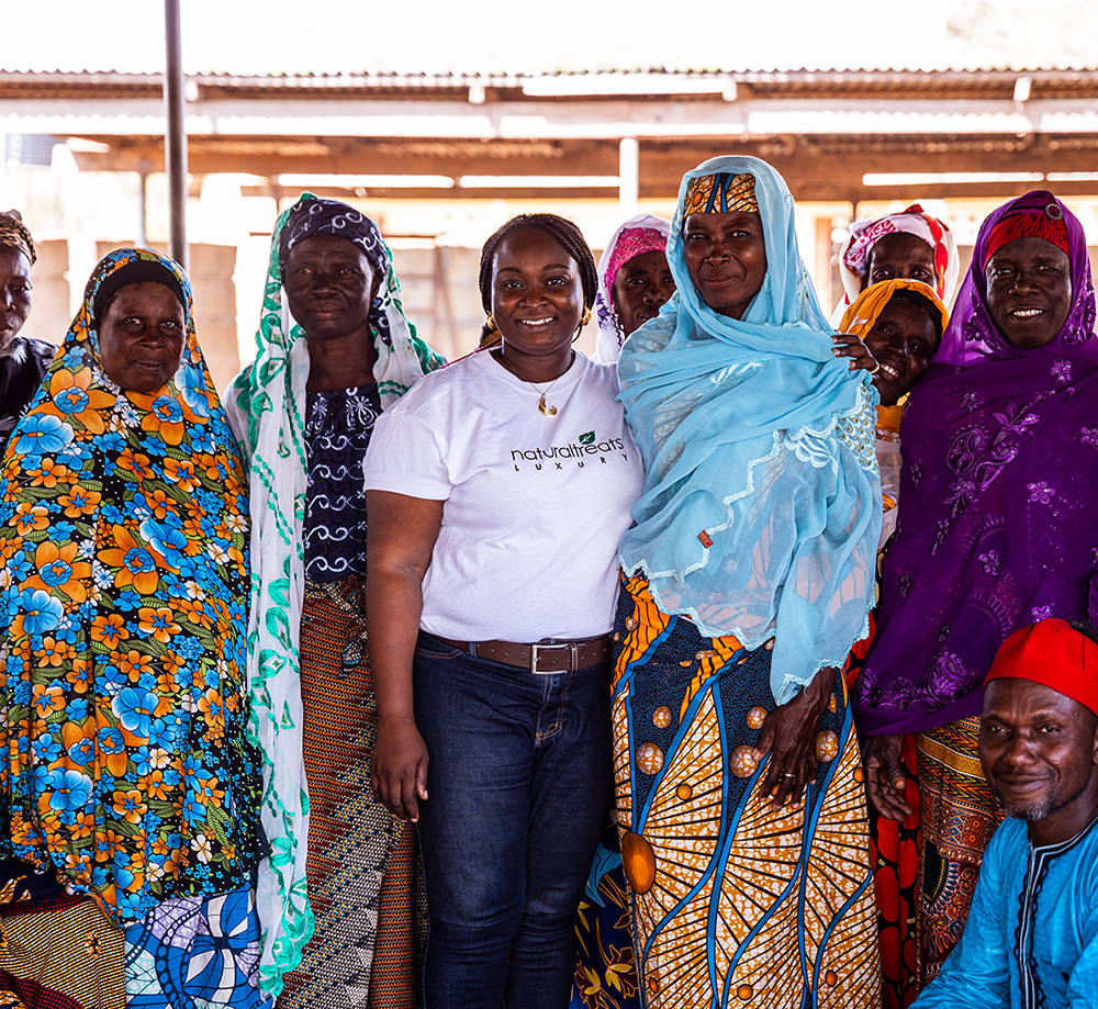 A group of people smiling for the camera wearing colorful traditional dress